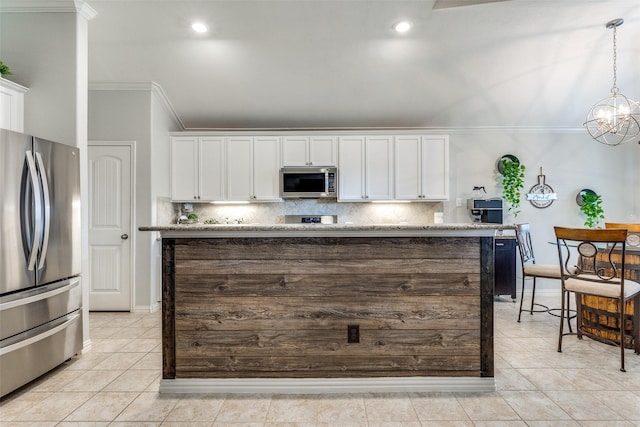 kitchen featuring crown molding, decorative backsplash, light tile patterned floors, white cabinets, and appliances with stainless steel finishes