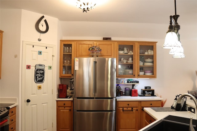 103 Sunglow Loop, Red Oak, TX 75154 - kitchen featuring glass insert cabinets, light countertops, freestanding refrigerator, and brown cabinets