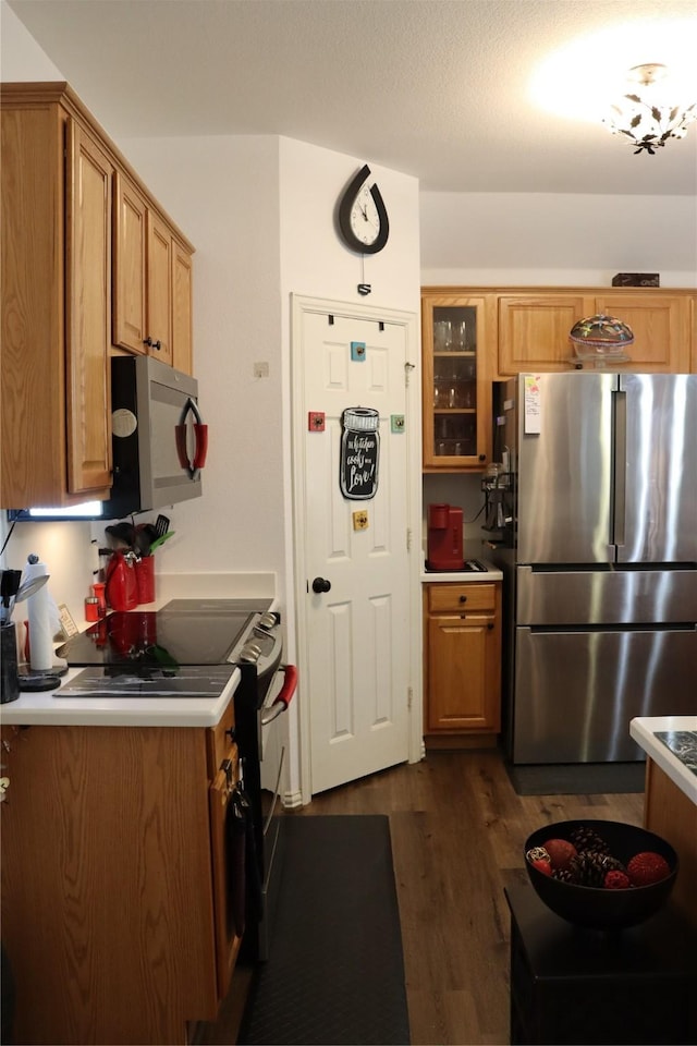 103 Sunglow Loop, Red Oak, TX 75154 - kitchen featuring brown cabinets, glass insert cabinets, light countertops, appliances with stainless steel finishes, and dark wood-type flooring