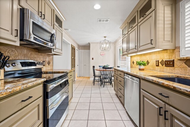 kitchen featuring glass insert cabinets, light tile patterned floors, an inviting chandelier, appliances with stainless steel finishes, and visible vents