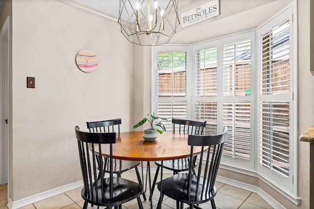 dining room with baseboards, light tile patterned flooring, and an inviting chandelier