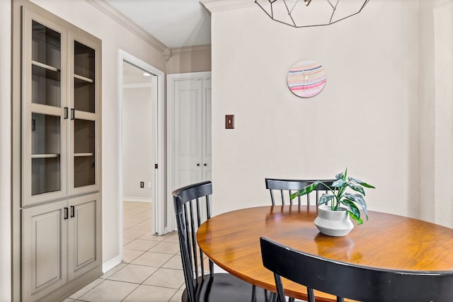 dining space with crown molding and light tile patterned floors