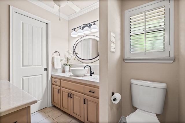 bathroom with tile patterned flooring, toilet, vanity, ornamental molding, and ceiling fan