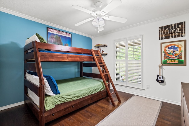 bedroom featuring wood finished floors, crown molding, baseboards, and a ceiling fan