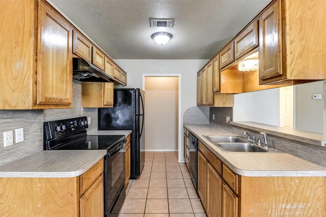 2545 E Renfro St, Burleson, TX 76028 - kitchen featuring black appliances, backsplash, under cabinet range hood, and a sink