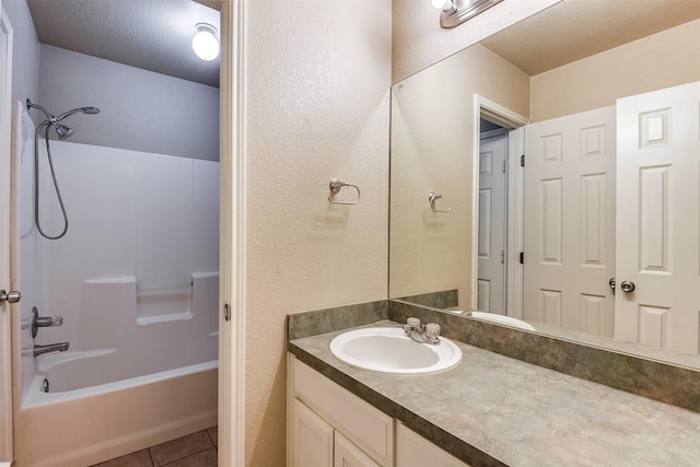 2545 E Renfro St, Burleson, TX 76028 - full bathroom featuring a textured wall, vanity, tile patterned floors, and shower / tub combination