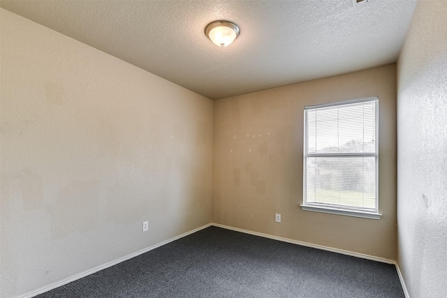 2545 E Renfro St, Burleson, TX 76028 - empty room with dark carpet, baseboards, and a textured ceiling