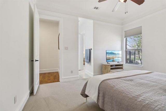 carpeted bedroom with baseboards, visible vents, and a ceiling fan