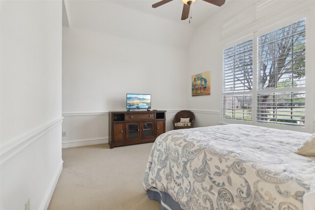 bedroom featuring ceiling fan, vaulted ceiling, and carpet