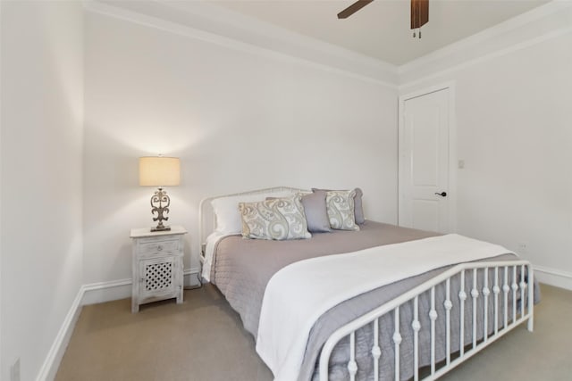 carpeted bedroom with ceiling fan and baseboards