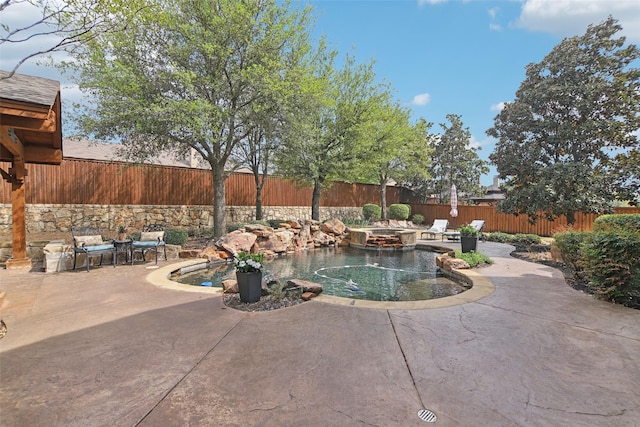 view of swimming pool with a fenced backyard, a fenced in pool, and a patio area