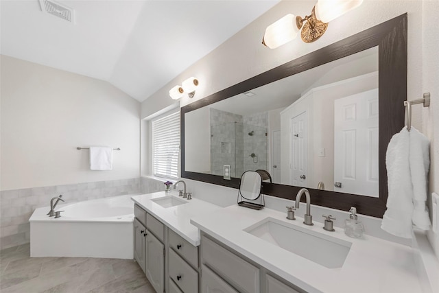 full bathroom featuring a shower stall, lofted ceiling, a sink, and visible vents