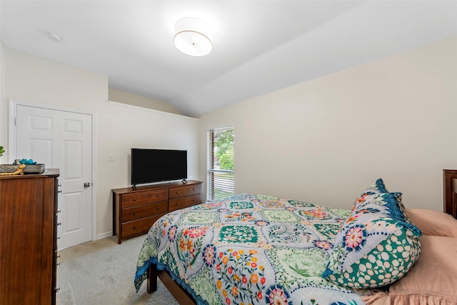 carpeted bedroom with lofted ceiling and baseboards
