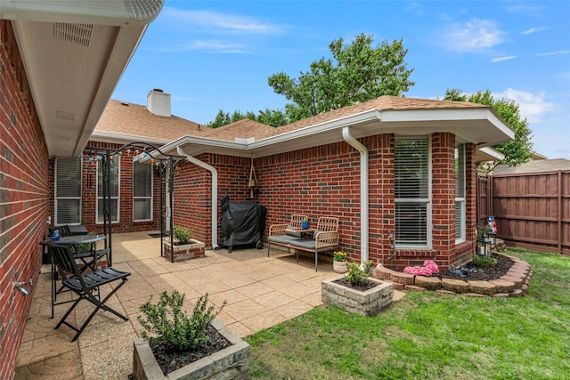 view of patio featuring grilling area and fence