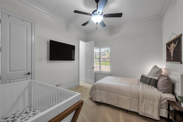 bedroom with a ceiling fan, baseboards, carpet, and crown molding
