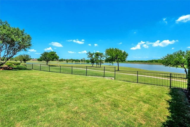 view of yard with fence and a water view
