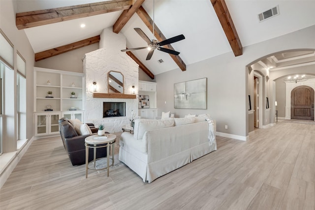 12524 Lake Shore Ct N, Fort Worth, TX 76179 - living area with arched walkways, a ceiling fan, beam ceiling, light wood-type flooring, and high vaulted ceiling