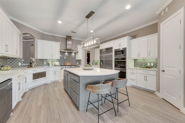 12524 Lake Shore Ct N, Fort Worth, TX 76179 - kitchen with wall chimney range hood, built in appliances, a warming drawer, tasteful backsplash, and a breakfast bar
