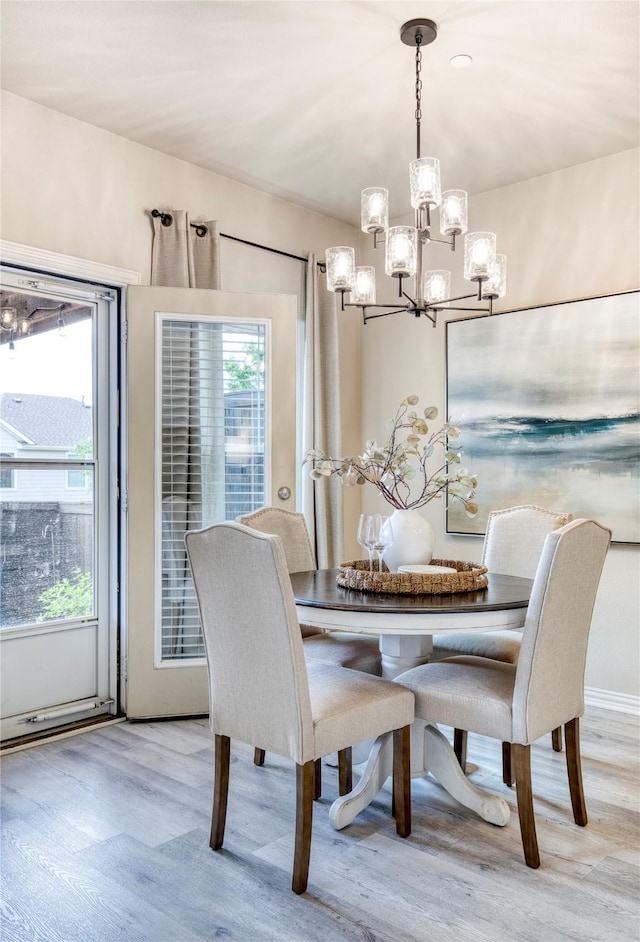 8741 Bigelow Dr, Plano, TX 75024 - dining room featuring a chandelier and wood finished floors
