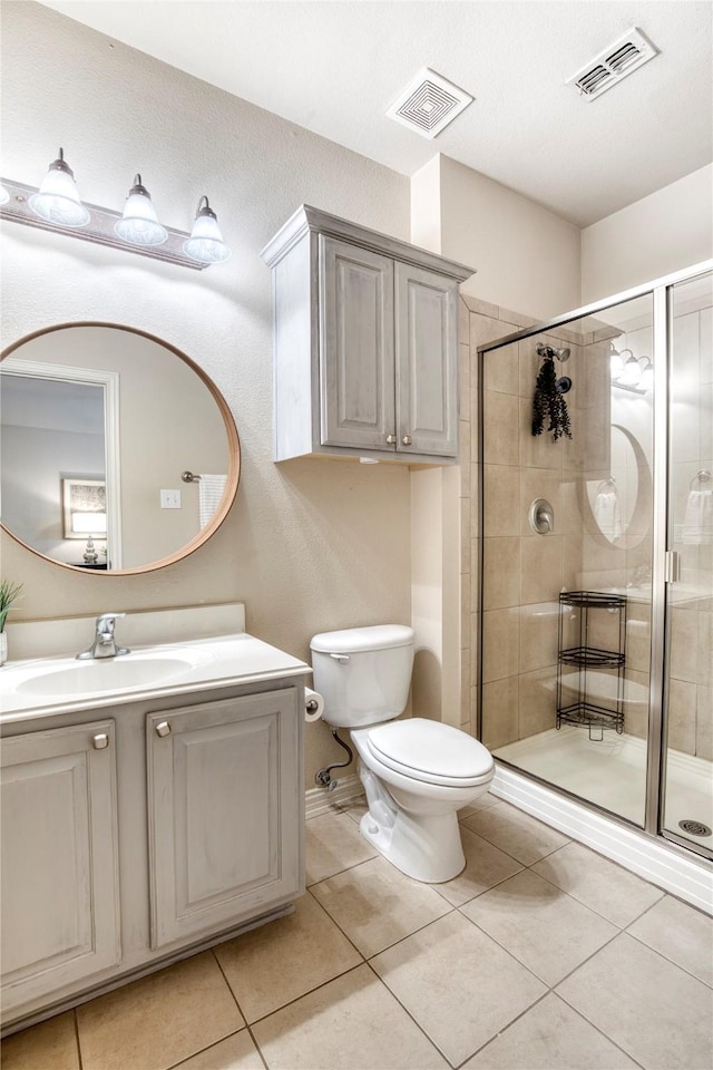 8741 Bigelow Dr, Plano, TX 75024 - bathroom featuring a shower stall, toilet, and tile patterned floors