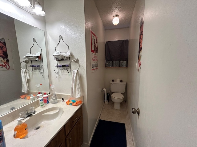 612 Ridgeline Dr, Hurst, TX 76053 - bathroom featuring toilet, vanity, a textured ceiling, baseboards, and tile patterned flooring