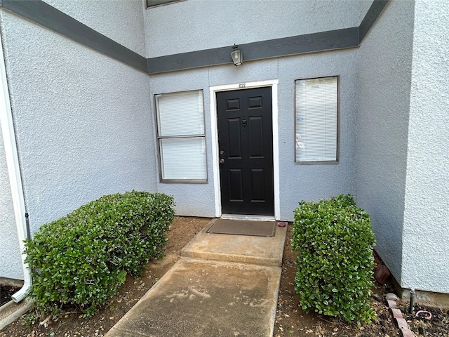 612 Ridgeline Dr, Hurst, TX 76053 - view of exterior entry with stucco siding