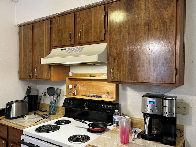 612 Ridgeline Dr, Hurst, TX 76053 - kitchen with electric range oven, under cabinet range hood, light countertops, and a textured wall
