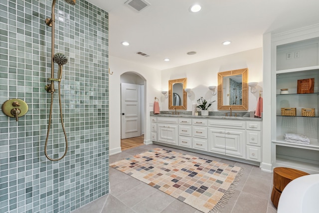 full bath with recessed lighting, double vanity, visible vents, and a sink