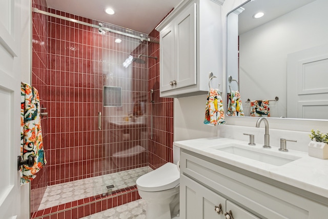 bathroom with recessed lighting, vanity, toilet, and a stall shower