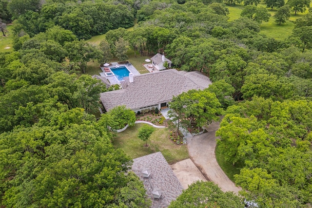 bird's eye view with a wooded view