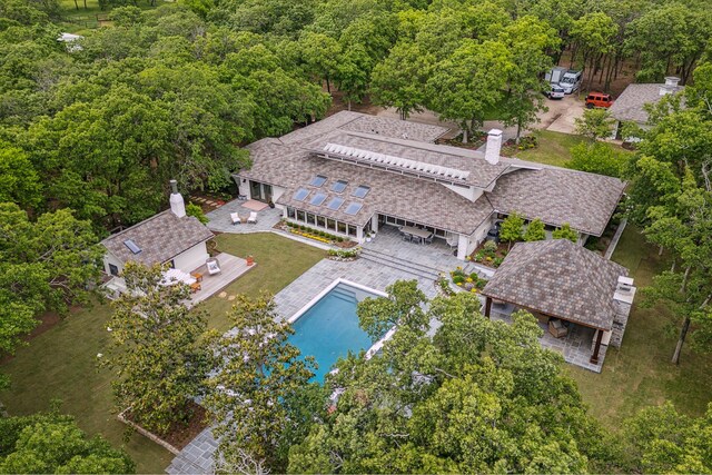 drone / aerial view featuring a wooded view