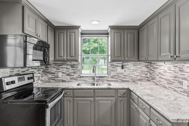 kitchen featuring backsplash, a sink, black microwave, stainless steel electric range, and gray cabinetry