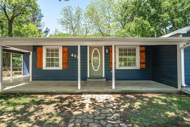 view of exterior entry with covered porch