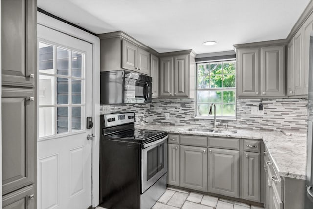 kitchen with black microwave, stainless steel electric range oven, a sink, and gray cabinetry