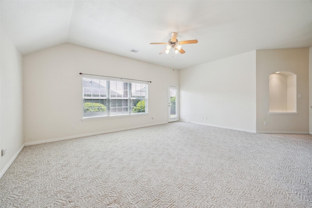 carpeted spare room with lofted ceiling, visible vents, baseboards, and ceiling fan