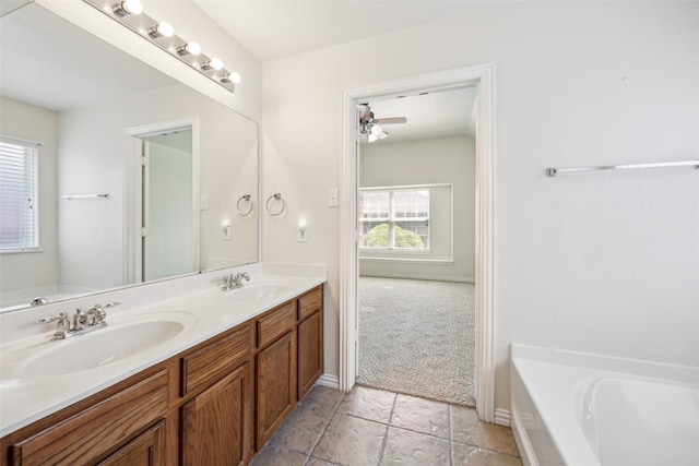 full bath featuring a garden tub, a sink, and double vanity