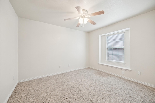 spare room featuring a ceiling fan, baseboards, and carpet floors