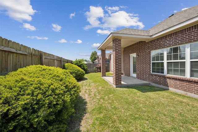 view of yard featuring a patio area and a fenced backyard