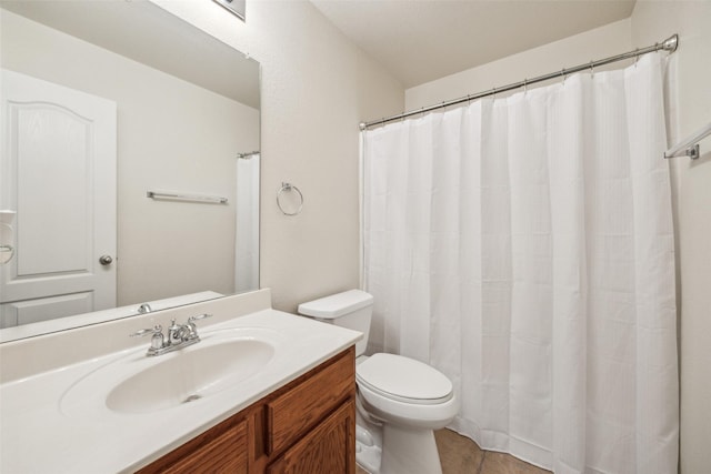 bathroom featuring toilet, vanity, and tile patterned floors