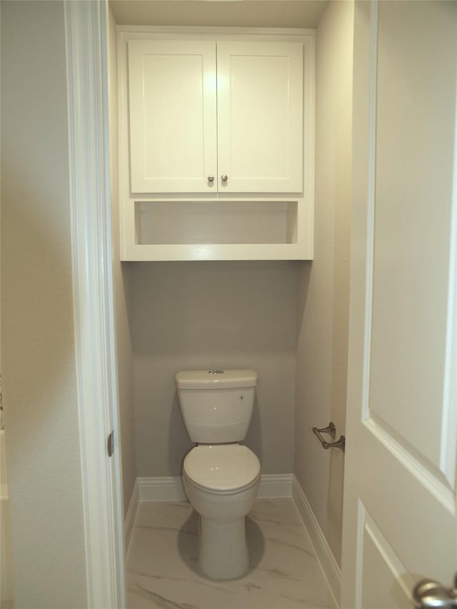 725 Raylan St, Springtown, TX 76082 - bathroom featuring marble finish floor, baseboards, and toilet
