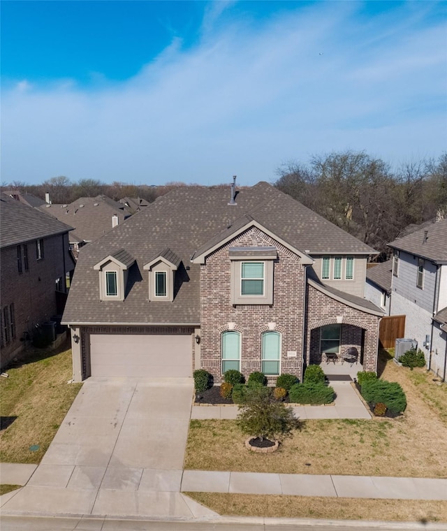 916 Sunset Haven Dr, Little Elm, TX 75068 - traditional-style house featuring concrete driveway, brick siding, roof with shingles, and a front lawn