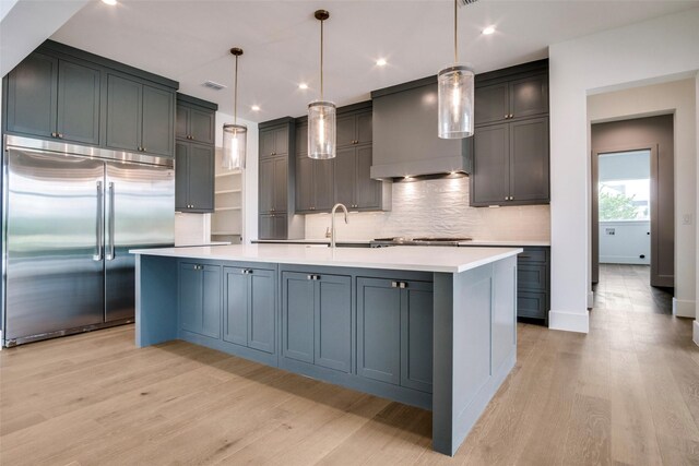 2016 Meadowlark, Aledo, TX 76008 - kitchen with wall chimney range hood, light wood-style flooring, a sink, and built in refrigerator
