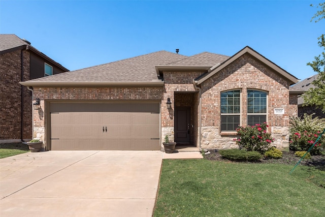 view of front of property featuring an attached garage, a shingled roof, brick siding, and concrete driveway