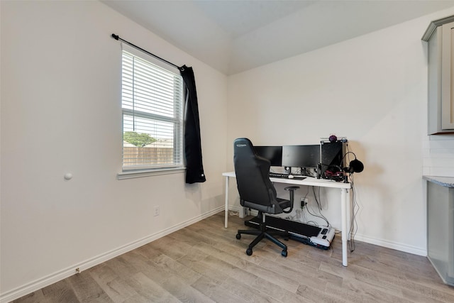 office with baseboards and light wood-style floors