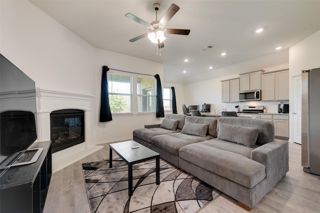 living area featuring recessed lighting, light wood-style flooring, visible vents, and a ceiling fan
