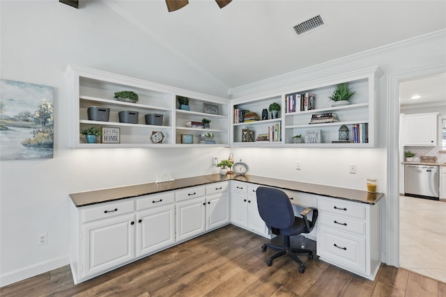 office space with built in study area, lofted ceiling, visible vents, a ceiling fan, and dark wood-style flooring