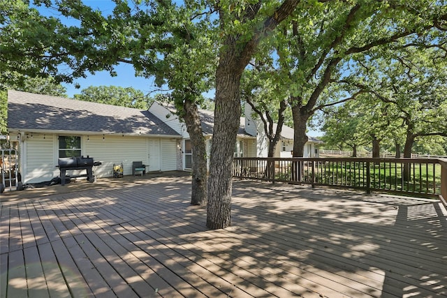 wooden deck with a grill