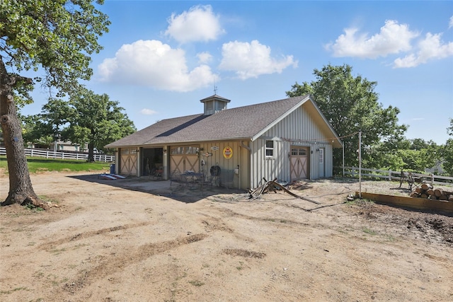detached garage featuring fence