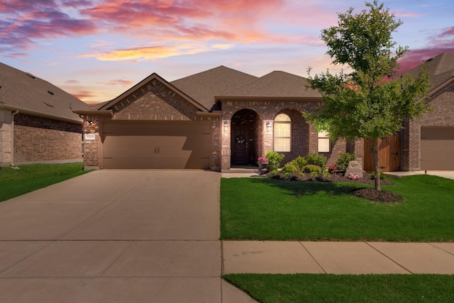 11225 Klondike Ln, Aubrey, TX 76227 - french provincial home with roof with shingles, brick siding, driveway, a yard, and a garage