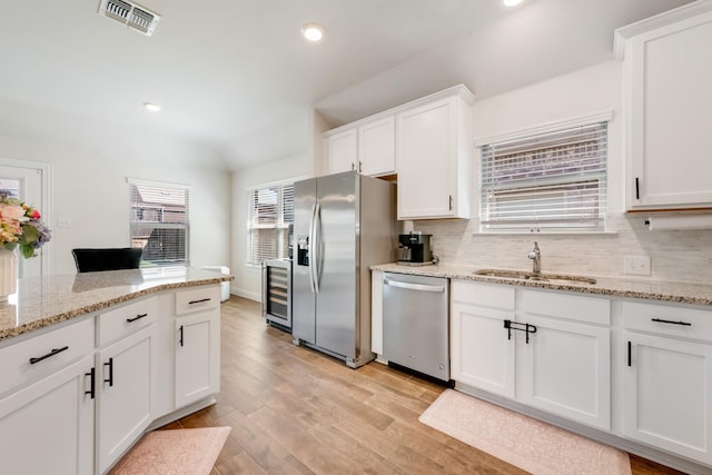 11225 Klondike Ln, Aubrey, TX 76227 - kitchen with a sink, tasteful backsplash, visible vents, beverage cooler, and appliances with stainless steel finishes